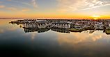 Havre de Grace, Maryland: Aerial sunset panorama with orange sky and clouds reflecting on the Susquehanna River and the Chesapeake Bay.