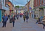 People walking around the shops in Brigend, Wales. Image credit: Colin Burdett via Shutterstock.