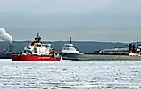 US Coast Guard ship and a grey cargo freighter near the Soo Locks. Editorial credit: T-I / Shutterstock.com