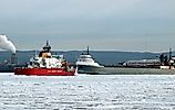 US Coast Guard ship and a grey cargo freighter near the Soo Locks. Editorial credit: T-I / Shutterstock.com