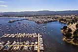 Aerial view of the Monterey Bay Aquarium, Pacific Grove with many yachts docked by the coastline in Monterey, central California.