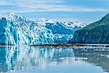 A view past an islet and the snout of the Hubbard Glacier into Russell Fjord in Alaska in summertime