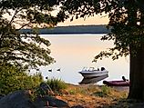 Two small boats at sunset at Watchaug Pond in Burlingame State Park, Charlestown Rhode Island 