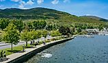People walking along a path by the water, Lake George, New York.