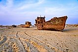 Rusty shipwreck lying on the seabed of the dried-up Aral Sea in Moynaq (or Muynak), a former fishing town in Karakalpakstan, Uzbekistan