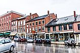 Brick buildings lined along the steep main street in Belfast, Maine. Image credit Kristi Blokhin via Shutterstock