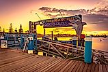 Port Macquarie, New South Wales, Australia: Entrance to dolphin cruise tours at sunset via Alex Cimbal / Shutterstock.com
