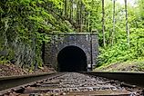 East Portal of the historic Hoosac Tunnel near North Adams, MA—an iconic 19th-century railroad tunnel framed by rugged stone and forested Berkshire scenery.