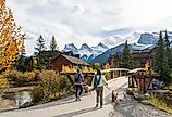 Residents walking their dogs in the town of Canmore in the fall season. Image credit Shawn.ccf via Shutterstock.