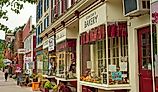 Shops, eateries, and baseball-themed attractions line the sidewalk on Main Street in Cooperstown, New York. Images Credits: Kenneth Sponsler via Shutterstock