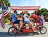 Surrey Bike with an American Flag in a Fourth of July Parade on Edisto Beach. Editorial credit: Coastal Soul Photography / Shutterstock.com