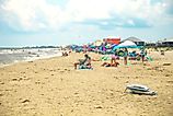 People enjoying a a busy summer beach day in Dauphin Island, Alabama. Image credit: HarrisonJeffs / Shutterstock.com