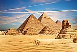 The Great Sphinx sits majestically by the Pyramids of Egypt in the Giza desert.