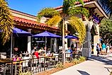 People enjoying an alfresco meal outside a restaurant in downtown Venice, Florida