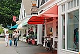 A young family walks through the charming Cape Cod town of Chatham, Massachusetts.