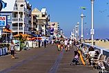 People walk on the Ocean City Boardwalk in Ocean City, Maryland. Image credit: George Sheldon / Shutterstock.com.