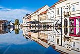 Scenic view of historic buildings and outdoor cafes reflected in a fountain under a bright blue sky in Koprivnica. (Editorial credit: Ivan Klindic / Shutterstock.com)