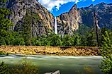 Bridalveil Fall cascading into Yosemite Valley with the Merced River in the foreground in Yosemite National Park, California. 