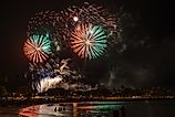 Fireworks light up the night sky over Hawaiian beach on Fourth of July. Via Shutterstock / Gordon Fahey. 