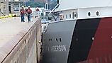 A crew member and shoreside line handlers help guide the Great Lakes freighter Arthur M. Anderson into the Poe Lock at Sault Ste. Marie, Michigan. 