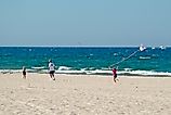 Girl flies kite on beach at Grand Haven State Park on Lake Michigan.
