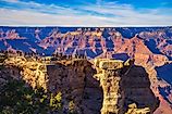 Tourists enjoy beautiful sunset above Grand Canyon National Park from Mather Point.
