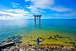 traveler woman and torii gate at Lake Biwa, Shiga Prefecture, Japan