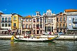 Boat on Canal and Art Nouveau, Novo, buildings in Aveiro in Portugal. (Editorial credit: Richie Chan / Shutterstock.com)