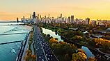 Aerial view of Chicago skyline at sunset, showing Lake Michigan shoreline