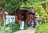 Landrum, South Carolina, USA-7 September 2025: Side view of The Hare and Hound restaurant, showing sign, covered outside dining with customers at tables, greenery. via J. Michael Jones on iStock.com