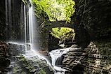 Rainbow Falls with a lady on bridge at Watkins Glen State Park