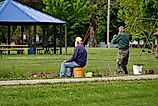 A group enjoying some lake fishing in Tomah, Wisconsin as part of a community event. Editorial credit: Aaron of L.A. Photography / Shutterstock.com