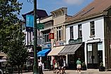 Shops, businesses, and dining establishments with sidewalk seating line the downtown block of Granville, Ohio. Editorial credit: Eric Glenn / Shutterstock.com