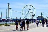 People walking in groups along the Atlantic City Boardwalk, NJ. Editorial credit: edwarda28 / Shutterstock.com