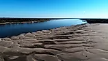 Aerial view from drone looking at low water on the Mississippi River. A line barge anchored on the left descending bank. Credit: Justin Wilkens/Shutterstock.com