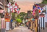 St. Augustine, Florida, shops and inns line St. George street with flags. Image credit Sean Pavone via Shutterstock