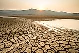 Cracked, dry lakebed caused by extreme heat and drought, illustrating the impact of climate change during summer.