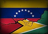 Flags of Venezuela and Guyana against a background of a wall with cracks. (Credit: Evgeny Simonov via Shutterstock)
