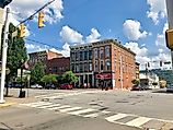 People walking along downtown Madison in Indiana. By Warren LeMay from Cullowhee, NC, United States - Main Street, Madison, IN, CC0, Wikimedia Commons.