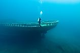 A diver inspects the bow of the wreck of the steel bulk freighter Grecian, where it rests in Lake Huron's Thunder Bay National Marine Sanctuary.