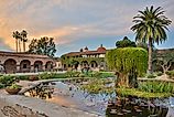Courtyard of Mission San Juan Capistrano in California at dusk.