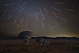 The Geminid Meteor shower taking place above the Very Large Array in New Mexico. Via Shutterstock / Liang Li Photos.