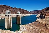 Hoover Dam intake towers in Lake Mead reservoir surrounded by desert canyon walls.