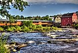 The River Walk Covered Bridge with the Grist mill on the Ammonoosuc River in Littleton, New Hampshire.