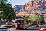 A trolley in Sedona, Arizona, gives a tour of the town under awesome sandstone formations. Image: Wollertz via Shutterstock. 