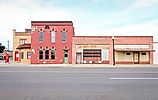 A colorful street corner with abandoned buildings in Oklahoma.