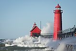 Waves crashing on lighthouse. Grand Haven lighthouse on Lake Michigan. Horizontal format.