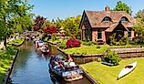  Boats filled with people along the canals in Giethoorn, Netherlands. Editorial credit: rob3rt82 / Shutterstock.com