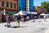 Four young men playing cornhole or corn toss in Elkin, North Carolina. Image credit:  J. Michael Jones / Shutterstock.com.
