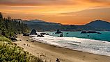 Sunrise at the beach with sea stacks at Battle Rock Wayside in Port Orford on the Oregon coast. Editorial credit: Bob Pool / Shutterstock.com
